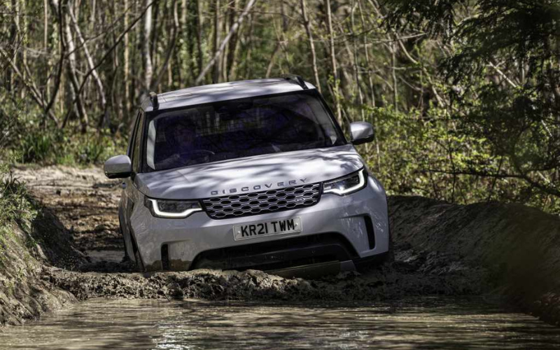 Land Rover Discovery driving through mud and water